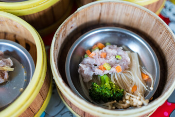 Steamed dumplings in a bamboo steamer basket. Close up