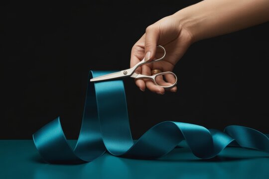 Hand Cutting Teal Ribbon with Scissors, Grand Opening, New Beginning, Celebration, Isolated on Black