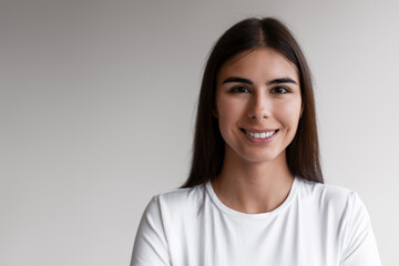 Obraz premium Smiling young woman wearing white t shirt portrait