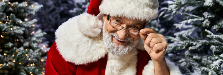 Joyful Santa Claus spreading holiday cheer among winter fir trees
