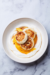 Homemade cottage cheese pancakes with yogurt and mango.