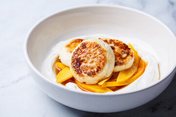 Homemade cottage cheese pancakes with yogurt and mango.