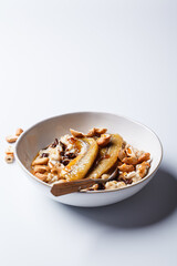 Oatmeal with banana, chocolate chips and nuts.
