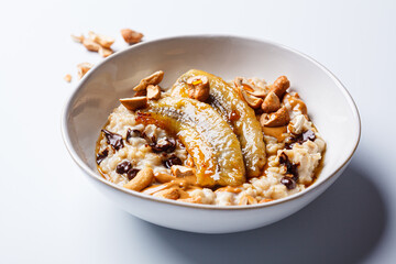 Oatmeal with banana, chocolate chips and nuts.