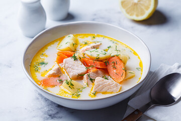 Finnish salmon soup with potatoes, carrots, and cream.