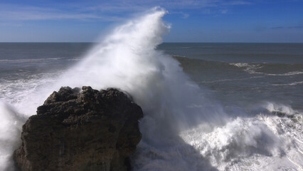 High waves breaking on rocks of coastline