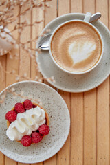 French berries cupcake with cappuccino. Cozy breakfast at the terrace