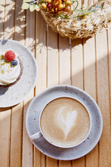 French berries cupcake with cappuccino top view. Cozy breakfast at the terrace