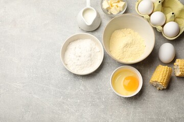 Cornbread preparation. Different ingredients on light grey table, flat lay. Space for text
