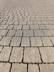pattern of gray stone paving slabs in a public city park