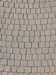 pattern of gray stone paving slabs in a public city park
