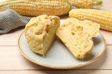 Freshly baked cornbread and cobs on wooden table, closeup