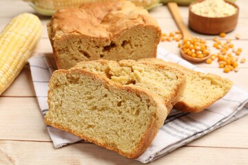Freshly baked cornbread, cobs and seeds on wooden table, closeup