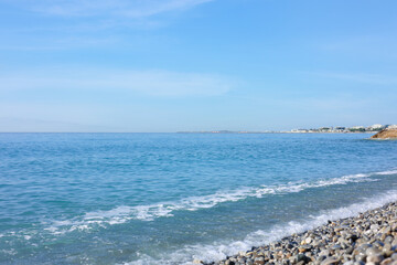 Beautiful view of wavy sea and pebbles on beach