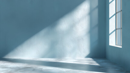 Empty blue room with light streaming through a window casting shadows on the textured wall and floor