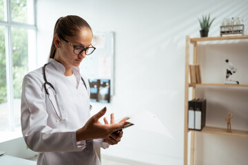 Doctor reading notes on a clipboard. Medicine and Healthcare concept