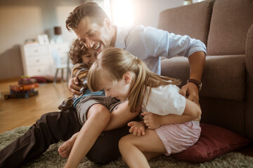 Father playing with children at home