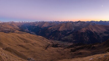 Naklejka premium Expansive mountainous landscape during twilight with rolling hills, autumnal colors, deep valley, lush greenery,