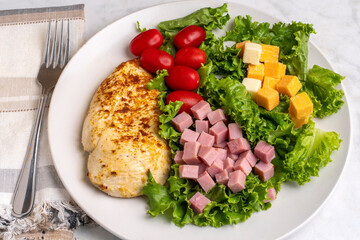 seasoned chicken breast with a salad