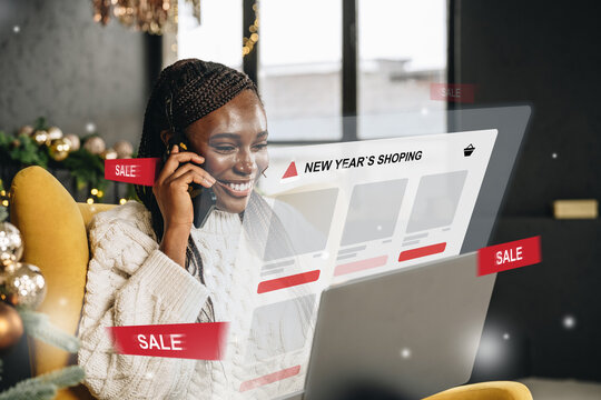 Enthusiastic shopper enjoys online sales while sitting in a cozy living room - Powered by Adobe