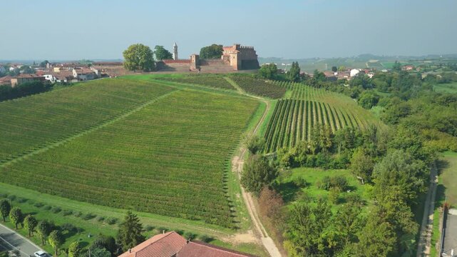 Aerial view, taken by a drone, of the hills, villages and vineyards of Monferrato Region. Monferrato is an hilly area in Piedmont Region (Northen Italy), world famous for wines making and UNESCO Site.