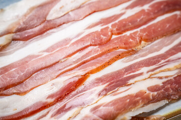 Raw bacon strips with fat marbling © zukamilov