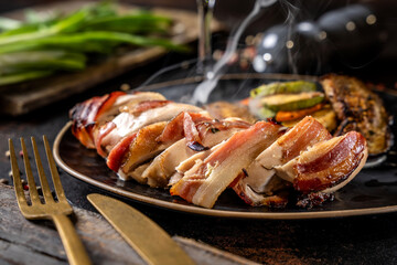 Steaming bacon wrapped chicken breast with vegetables