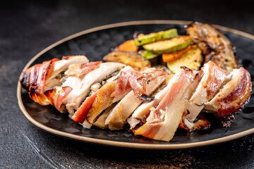 Bacon wrapped chicken breast with roasted vegetables