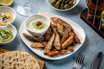 Mediterranean fried sardines with tzatziki and pita