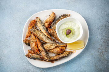 Fried sardines with tzatziki sauce