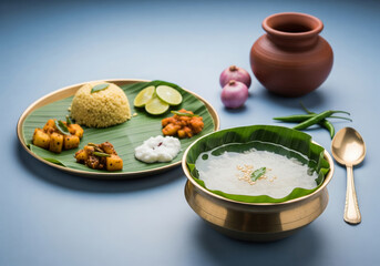 An appetizing Odia pakhala platter featuring fermented rice served with an array of traditional side dishes in beautiful brass bowls.