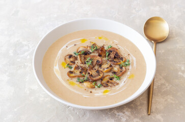 Mushroom cream soup with champignons and thyme. Healthy diet. Vegetarian food.