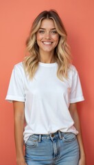 Obraz premium Young woman in white t-shirt smiles on coral background. Beautiful blondie girl wears casual blue jeans. Cheerful female shows happy face emotion, enjoy positive vibes, stands near clean empty wall.