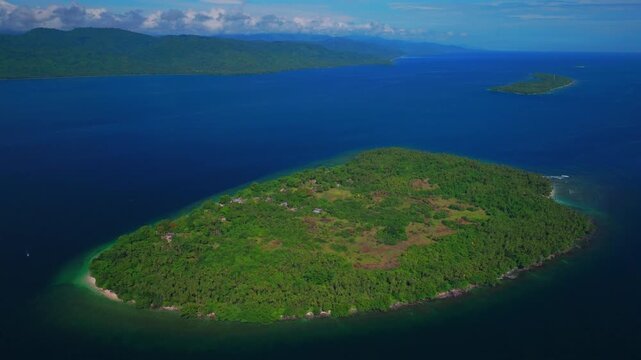 Yuo Island remote pristine untouched tropical Mushi island coastline village Wewak Madang Cape Wom Papua New Guinea aerial drone PNG dry season summer morning bleu sky power fishing boat backwards