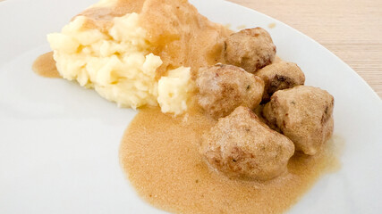 Creamy meatballs in velvety gravy dance beside fluffy mashed potatoes, evoking Swedish Midsummer and cozy comfort food nostalgia
