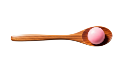 Wooden spoon holds a pink tangyuan as an inviting dessert in a cozy kitchen setting