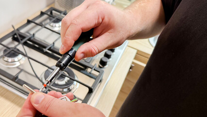 A Caucasian man's hands meticulously repair electronics, sparking innovation akin to Inventors' Day or Tinkering Workshop Escape