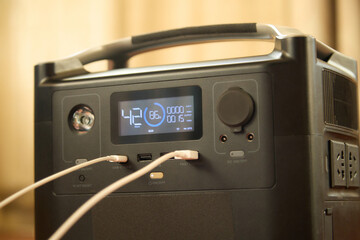 Fototapeta premium Portable power station charging a phone close-up. Backup energy