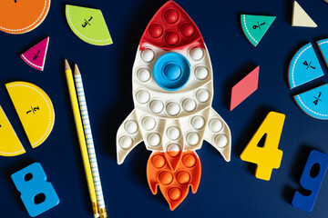 space rocket and math fractions on blue background. back to school