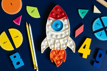 space rocket and math fractions on blue background. back to school