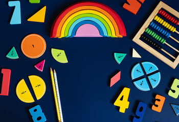 Colorful educational toys for children displayed on a dark surface during a playful learning session. back to school background