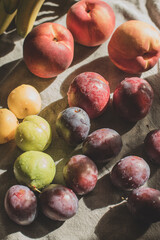 Ripe, Bright Peaches and Plums on the Table