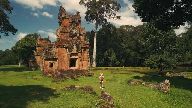 Drone Following Female Tourist Walking By Suor Proat Temple In Angkor Thom
