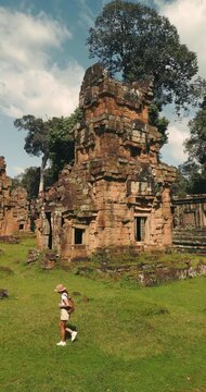 Vertical Drone Video Following Tourist Walking Among Suor Proat Temples Cambodia