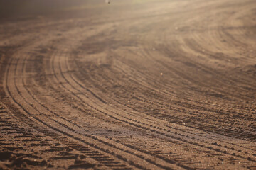 Naklejka premium tire tread marks on a clay road, abstract texture background