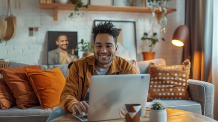 Smiling man using laptop home