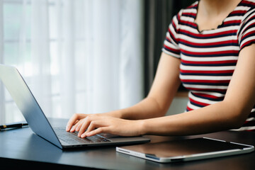 Fototapeta premium Businesswoman hands typing on smartphone and laptop keyboard in morning light computer, typing, online in office
