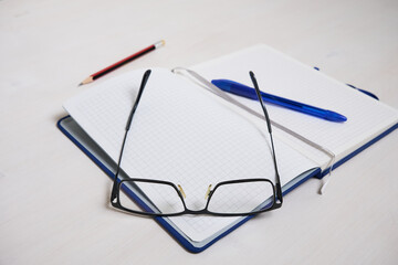 glasses lying on a notebook close-up