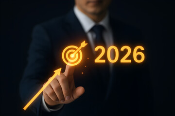 Business professional pointing at glowing 2026 target icon – concept of goal setting, strategic planning, and future growth