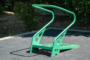 Green public exercise machine in urban park for healthy lifestyle and physical activity